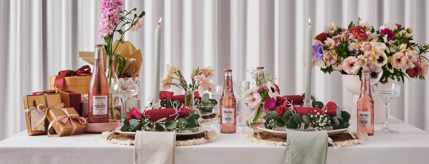 friendsmas table spread with pink and flowers, aesthetic festive spread, christmas, brutal fruit, home entertaining, festive season, the suite, the suite edit