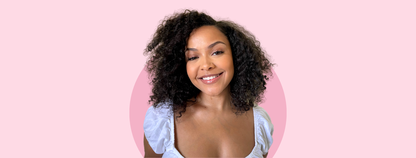 Nwabisa Jessica Ntoto, model with curly hair against a pink background smiling, curly hair, the suite, the suite edit, you belong here, brutal fruit